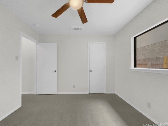 carpeted empty room featuring ceiling fan