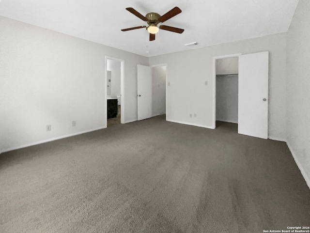 unfurnished bedroom featuring connected bathroom, carpet floors, and ceiling fan