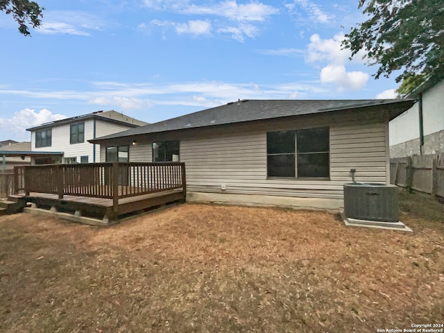 rear view of house with a wooden deck and cooling unit