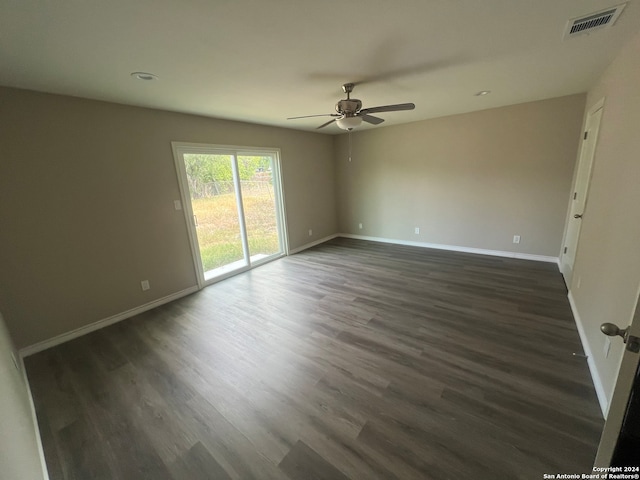 unfurnished room featuring ceiling fan and dark hardwood / wood-style flooring