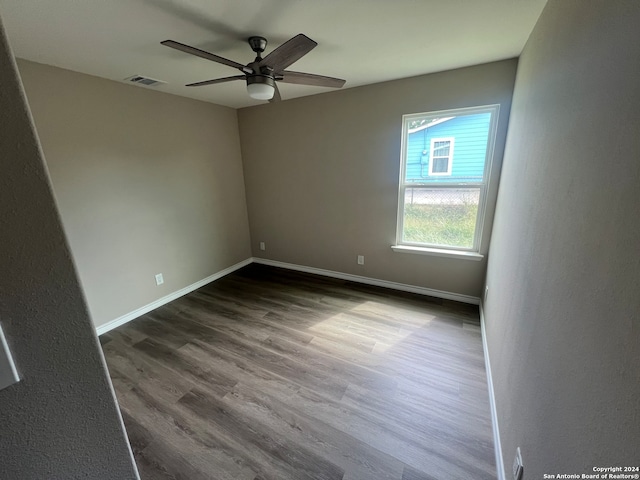 spare room with hardwood / wood-style flooring and ceiling fan