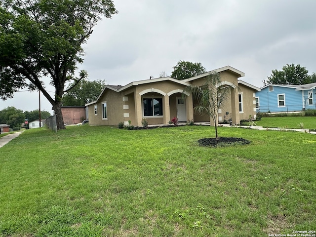 ranch-style house with a front lawn