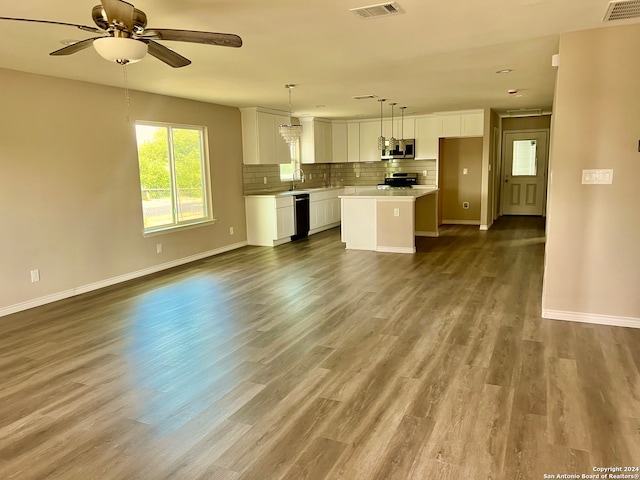 unfurnished living room featuring ceiling fan, sink, and hardwood / wood-style floors