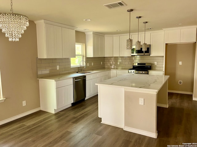 kitchen with appliances with stainless steel finishes, white cabinetry, decorative backsplash, and dark hardwood / wood-style floors