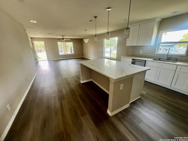 kitchen with a kitchen island, dark hardwood / wood-style floors, sink, and white cabinetry