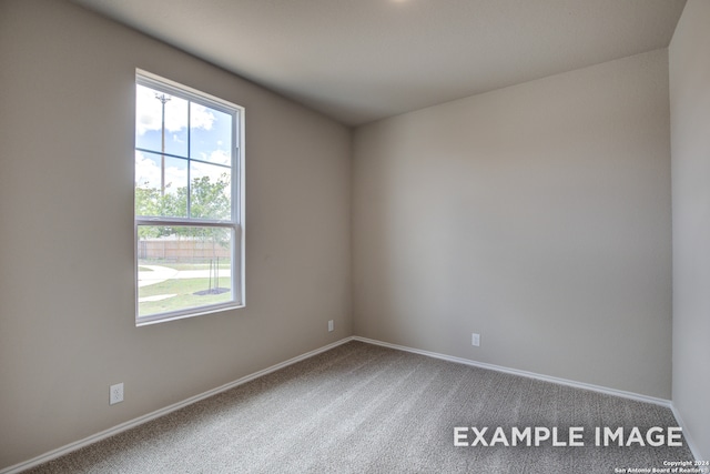 unfurnished room featuring carpet flooring and baseboards