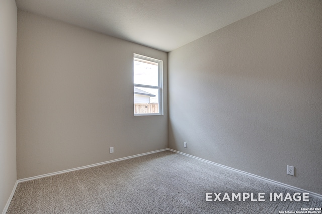 carpeted spare room with baseboards