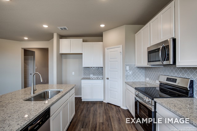 kitchen featuring white cabinetry, appliances with stainless steel finishes, light stone counters, and a sink