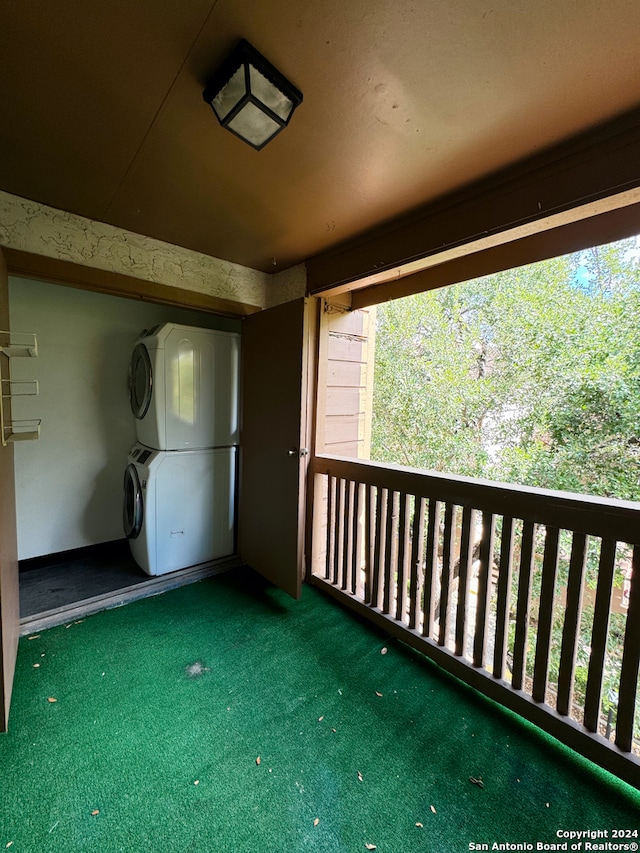 exterior space featuring stacked washer / drying machine