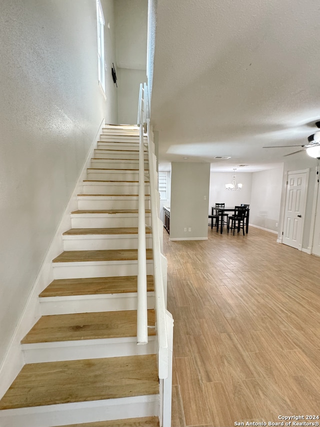 staircase featuring ceiling fan, hardwood / wood-style flooring, and radiator