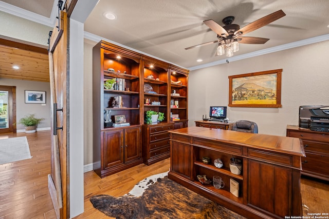 office with ceiling fan, a barn door, light hardwood / wood-style floors, a textured ceiling, and crown molding