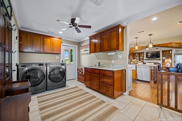 laundry area with sink, cabinets, light wood-type flooring, washer and dryer, and ceiling fan