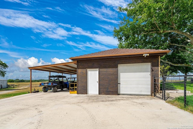 garage featuring fence and a garage