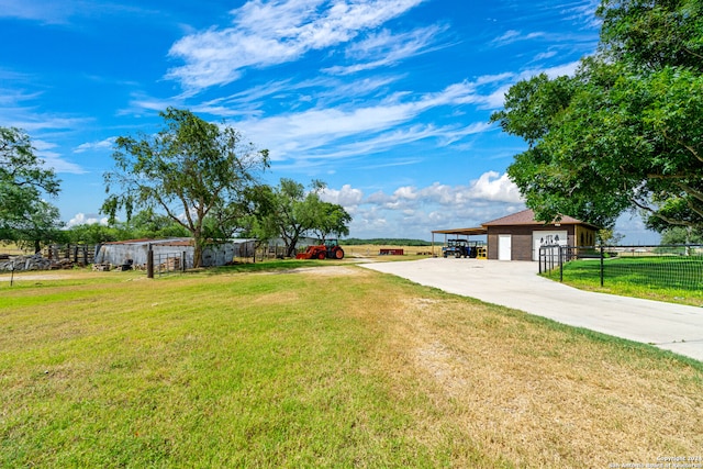 ranch-style house featuring an outdoor structure, a garage, and a front yard