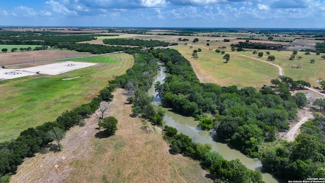 birds eye view of property with a rural view and a water view