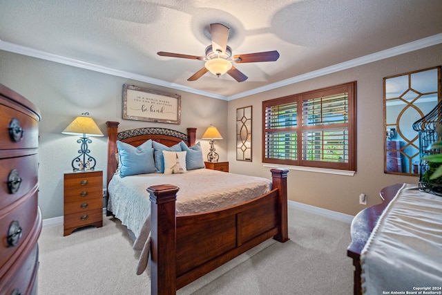 carpeted bedroom with ceiling fan, ornamental molding, and a textured ceiling