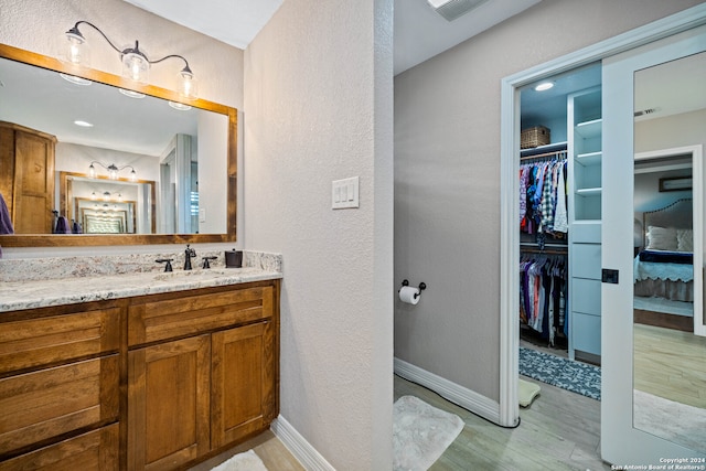 bathroom featuring hardwood / wood-style flooring and vanity