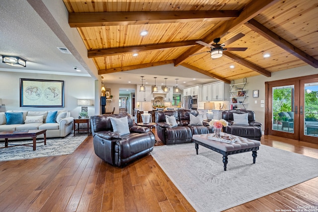 living room with ceiling fan, dark wood-type flooring, wooden ceiling, and beamed ceiling