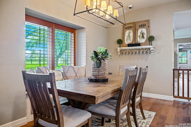 dining room featuring baseboards, an inviting chandelier, and wood finished floors