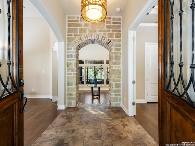 foyer entrance with hardwood / wood-style flooring and ornamental molding