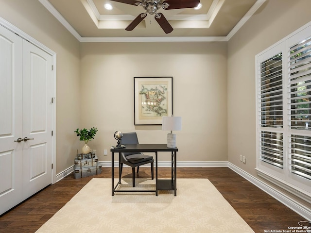 office space with ceiling fan, a tray ceiling, and dark wood-type flooring