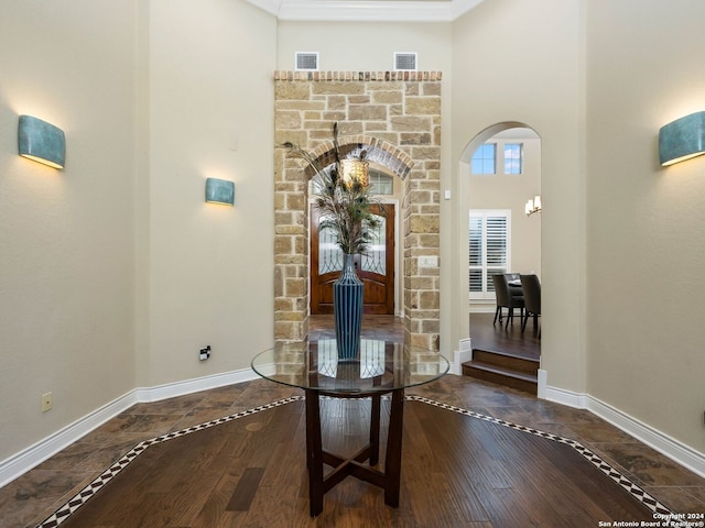 interior space featuring hardwood / wood-style flooring and ornamental molding