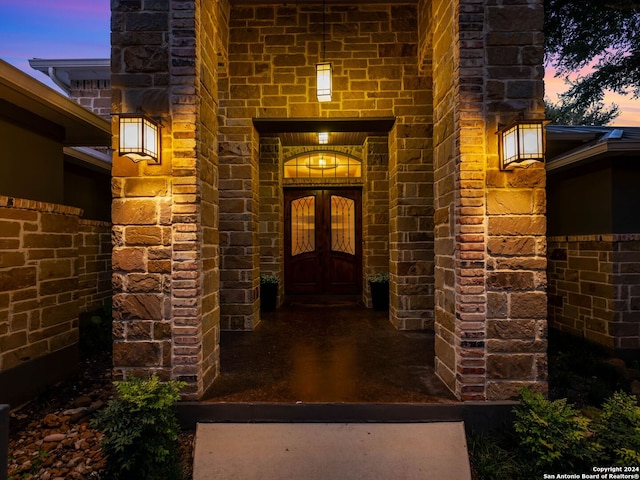 view of exterior entry at dusk