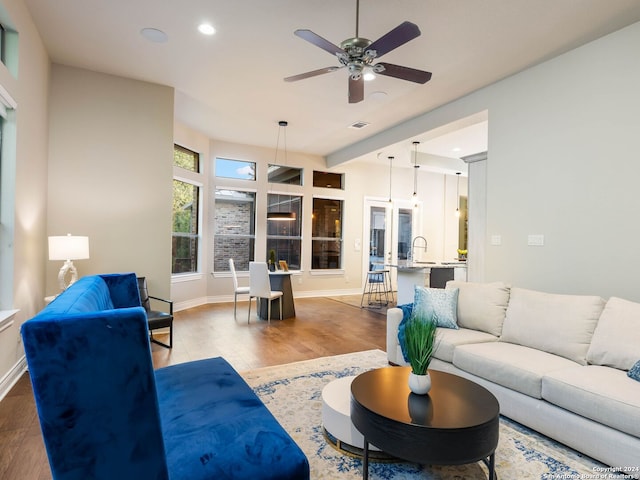 living room with ceiling fan and hardwood / wood-style flooring