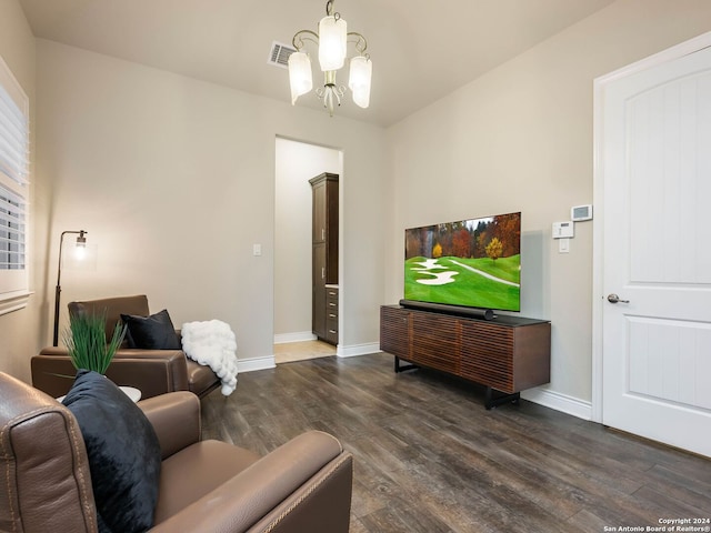 living room featuring an inviting chandelier and dark hardwood / wood-style floors