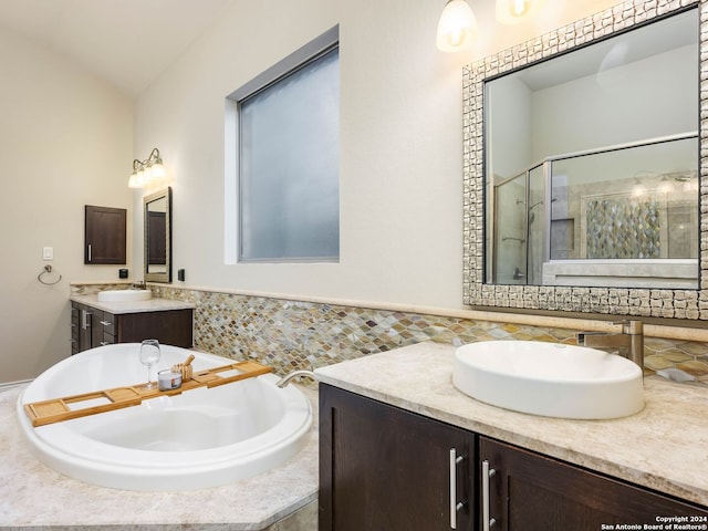 bathroom with independent shower and bath, vanity, and decorative backsplash