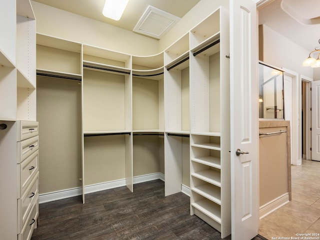 walk in closet featuring dark wood-type flooring