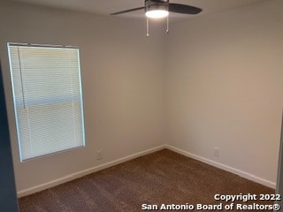 spare room featuring carpet flooring and ceiling fan