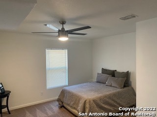 bedroom featuring ceiling fan and dark colored carpet