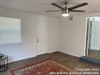 foyer entrance with ceiling fan and dark hardwood / wood-style floors