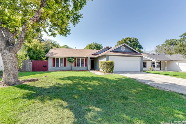 single story home with a garage and a front lawn