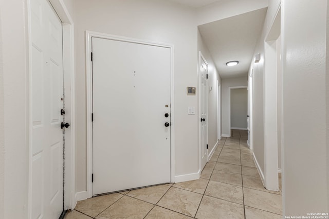 hall featuring light tile patterned floors