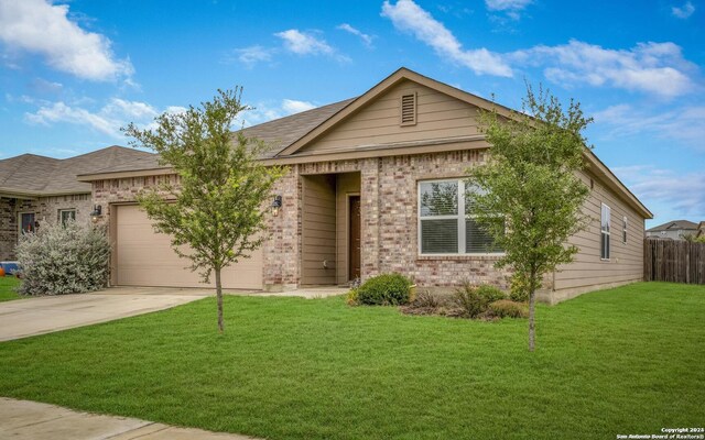 view of front of home featuring a garage and a front lawn