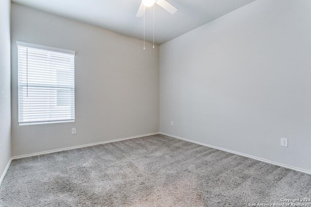 empty room with carpet and ceiling fan