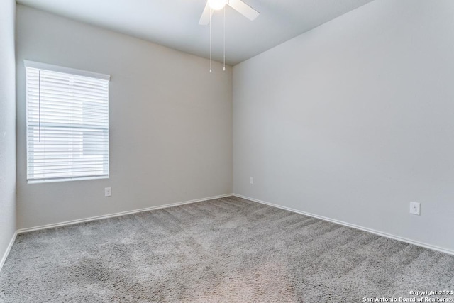 unfurnished room featuring carpet floors, ceiling fan, and baseboards