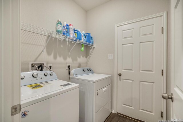 laundry room with dark wood-type flooring and washing machine and dryer