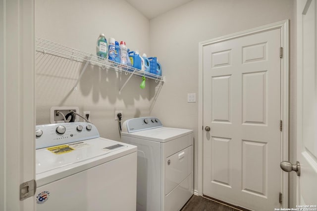 washroom with washing machine and dryer, laundry area, and dark wood finished floors