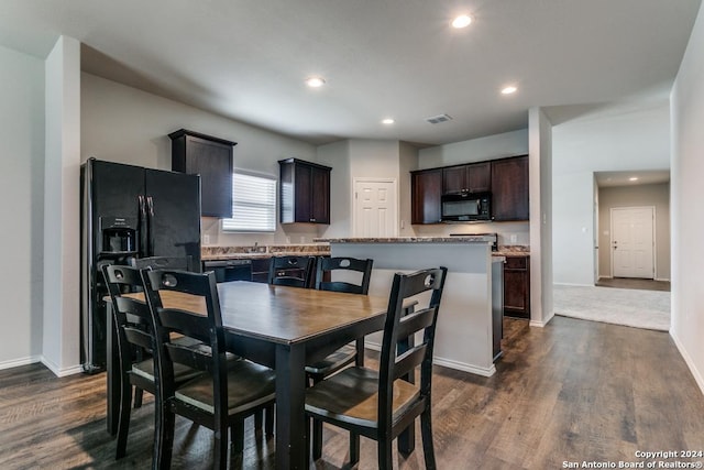 dining room with baseboards, dark wood finished floors, visible vents, and recessed lighting