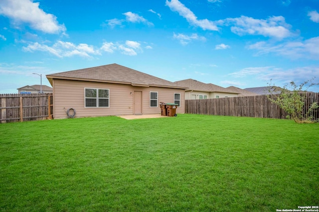 back of house featuring a yard and a patio area