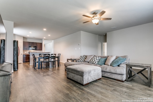 living room featuring hardwood / wood-style floors and ceiling fan