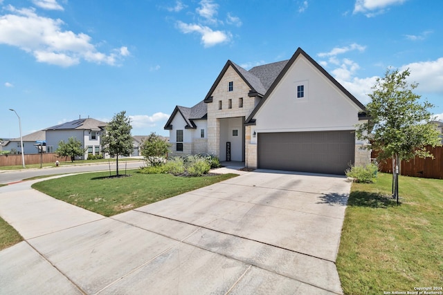 view of front of house with a garage and a front yard