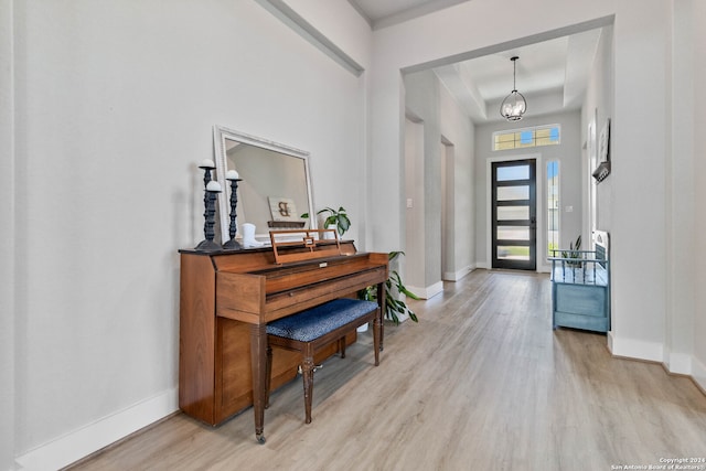 foyer entrance featuring light hardwood / wood-style flooring and a chandelier