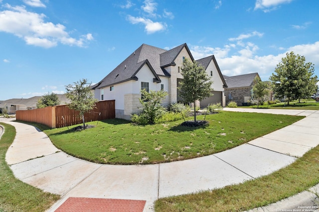 view of home's exterior with a garage and a lawn