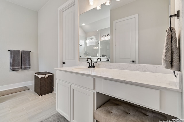 bathroom featuring a shower with shower door, tile patterned flooring, and vanity