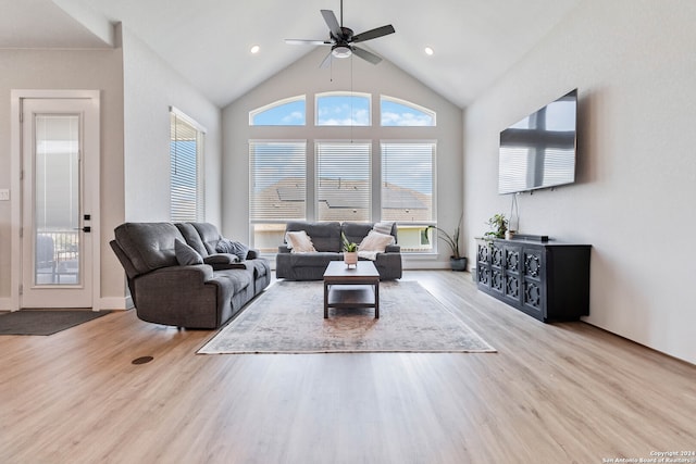 living room featuring ceiling fan, light wood-type flooring, and high vaulted ceiling