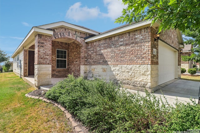 ranch-style home featuring a garage and a front yard